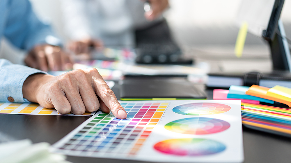 Two creative graphic designer team working on color selection an